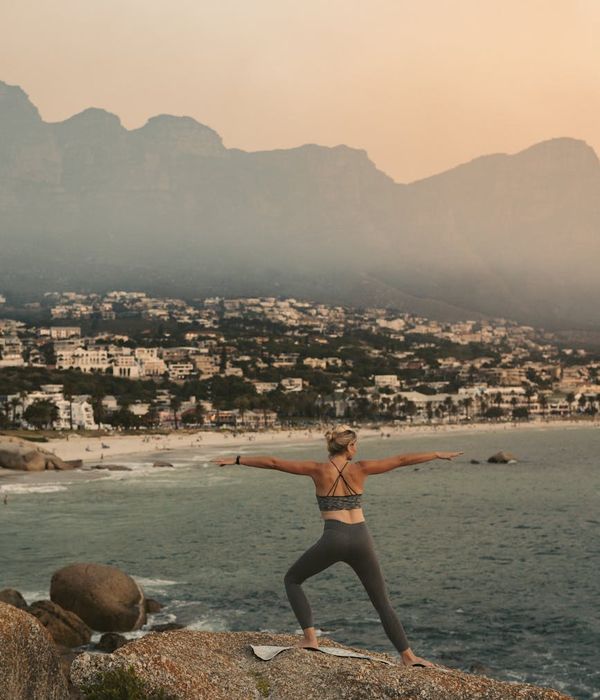 Woman in a peaceful yoga pose, surrounded by a calm lavender glow.